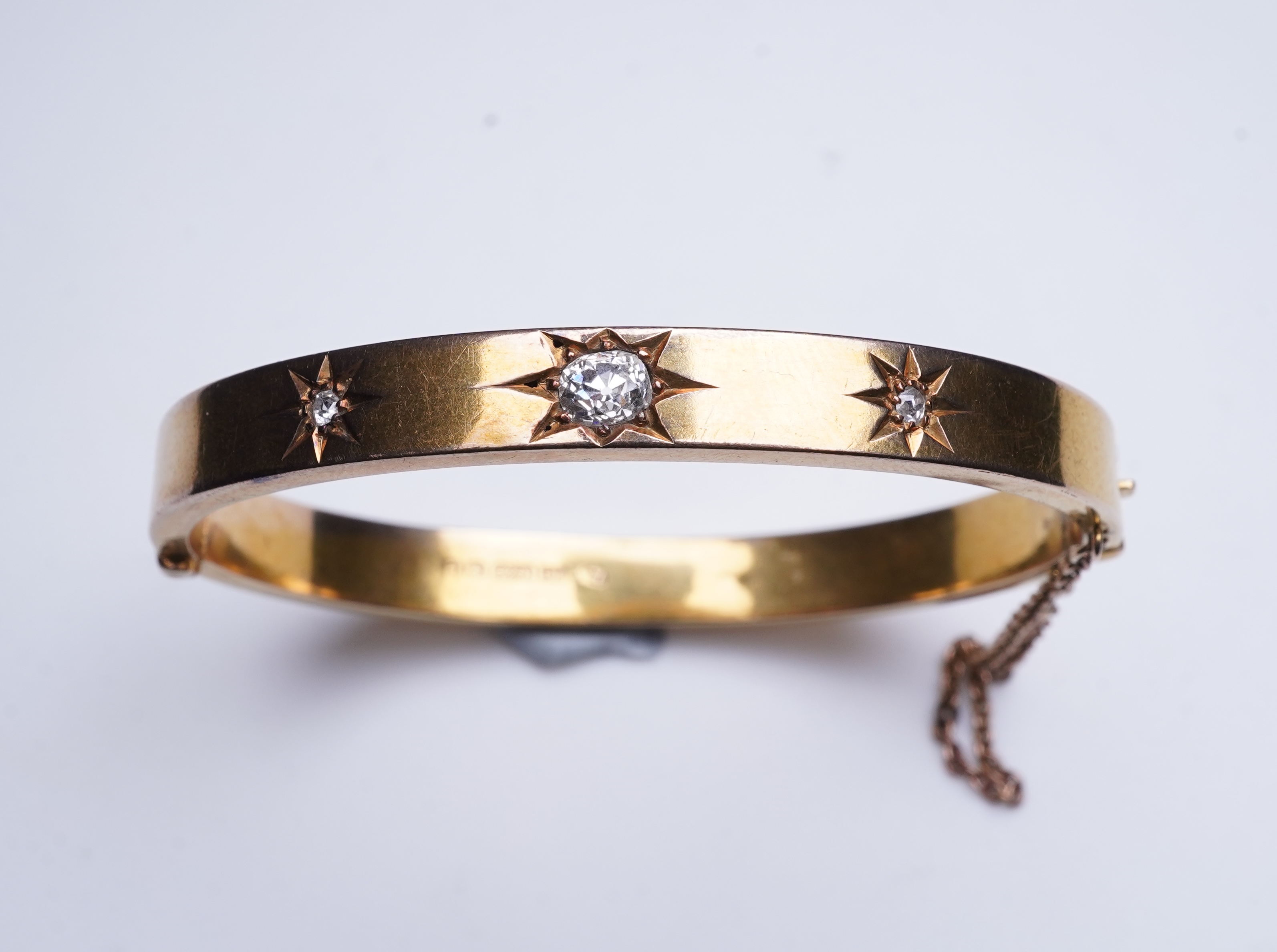 An Edwardian 15ct gold and diamond bangle, circa 1904